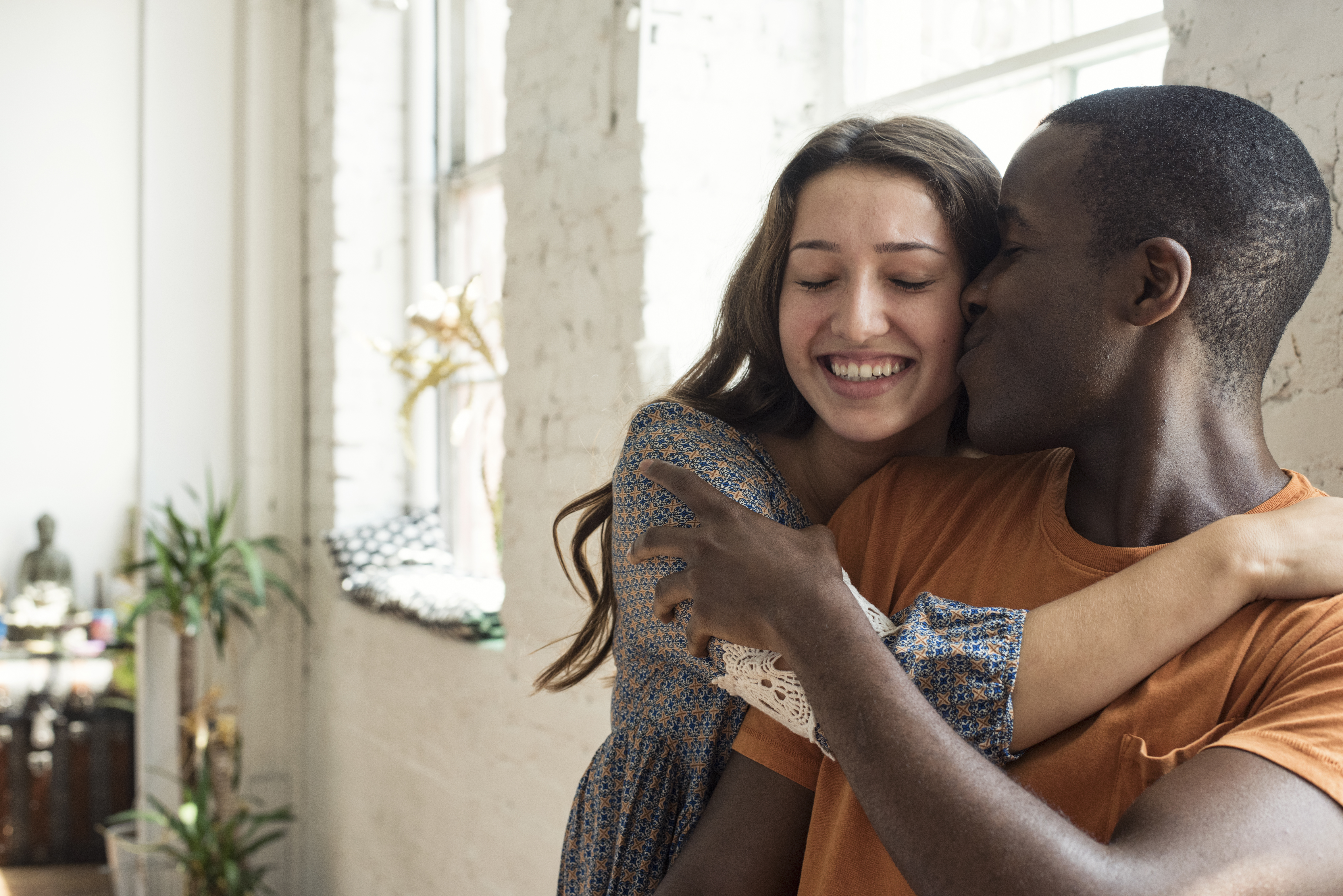 Happy young couple hugging in a loft
