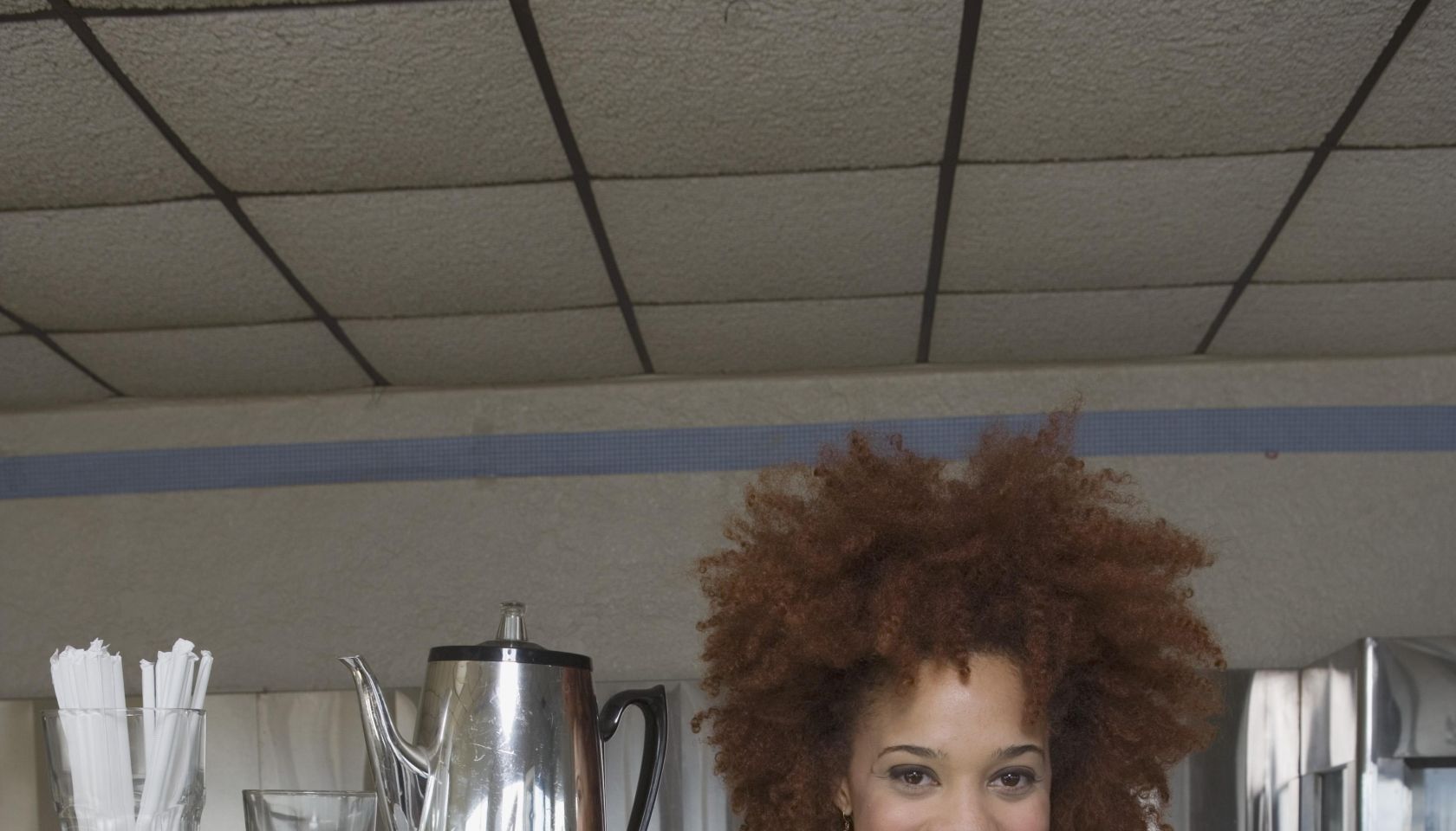 Waitress carrying tray of coffee and cup