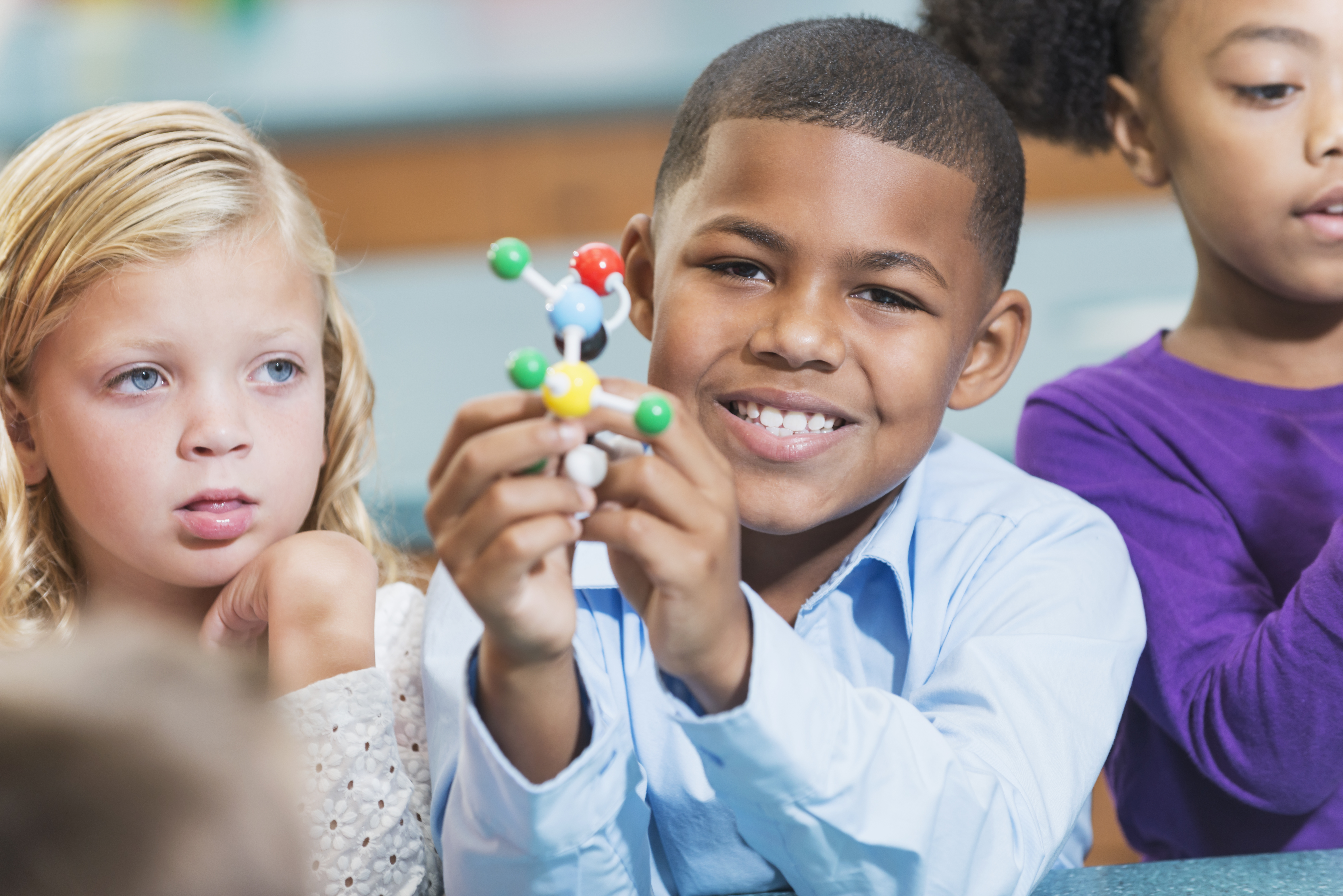 African American boy and friends in science class