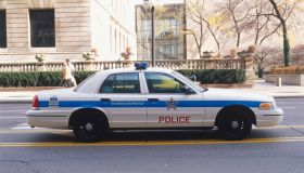 USA, Illinois, Chicago, police car driving along street, side view.