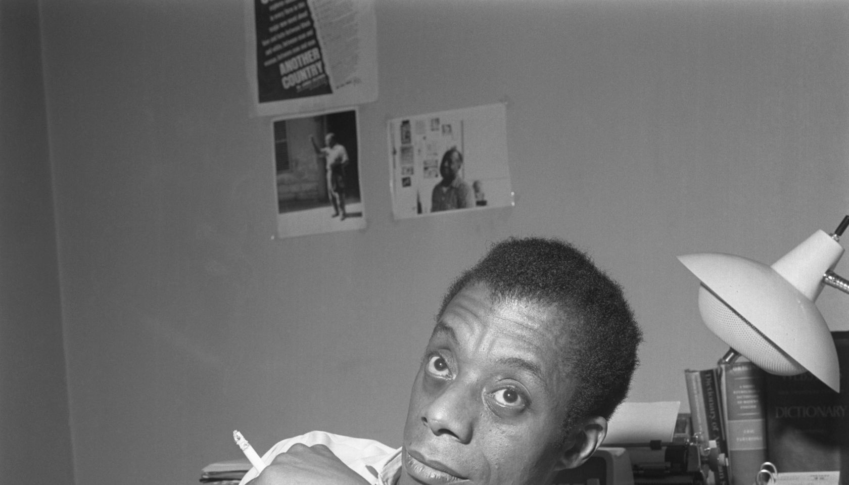 James Baldwin Sitting Smoking A Cigarette
