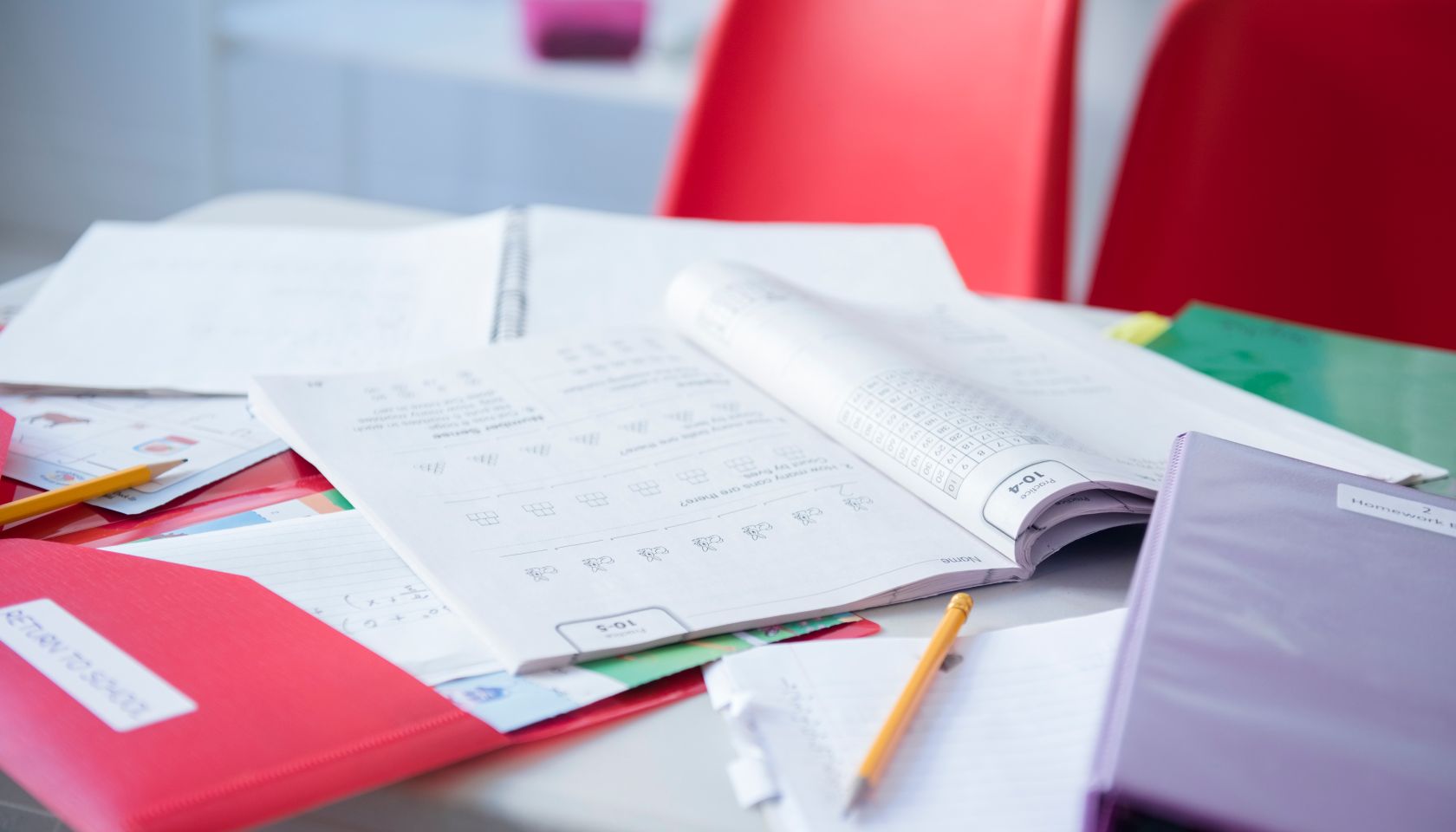 Workbook and folder on desk in classroom