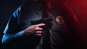 Police Officer Holding Gun