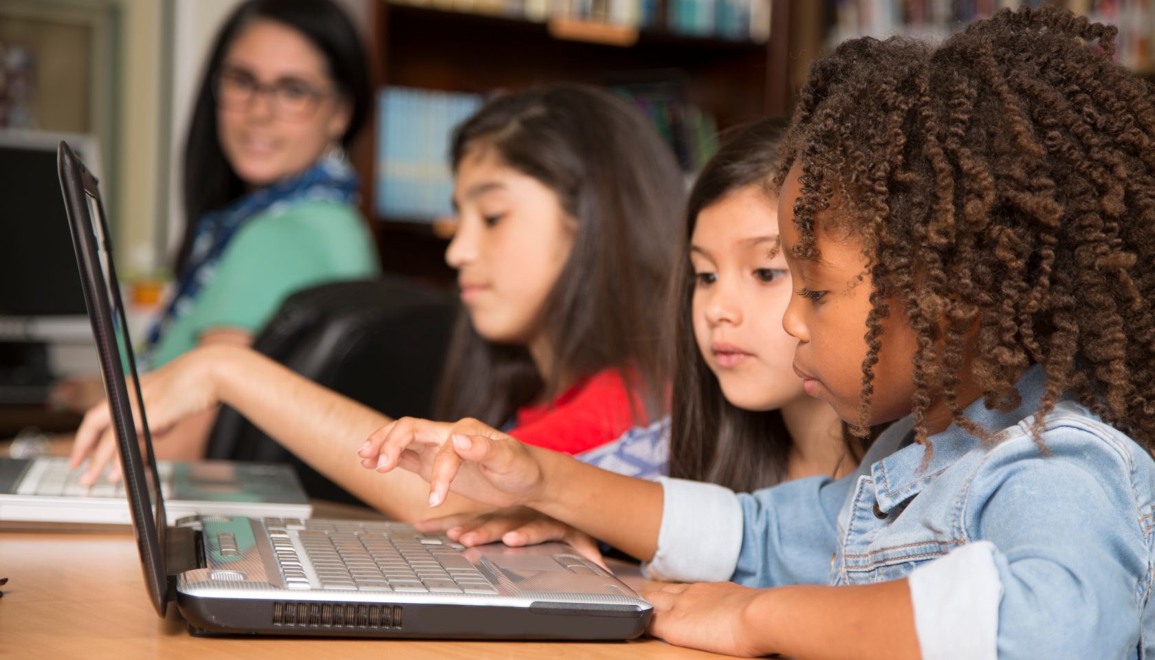 Elementary-age children learn computer coding in school.
