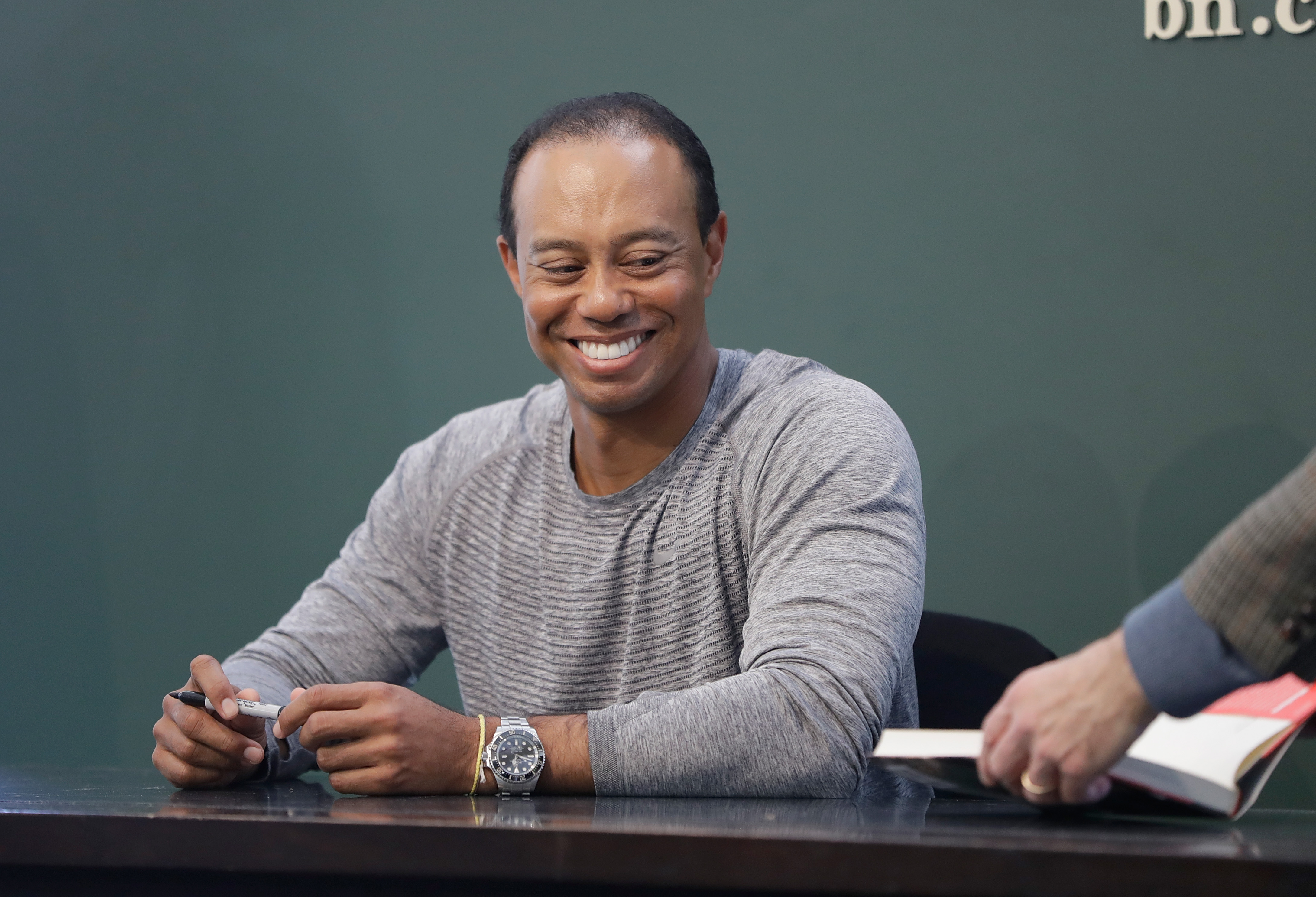 Tiger Woods Signs Copies Of His New Book 'The 1997 Masters: My Story'