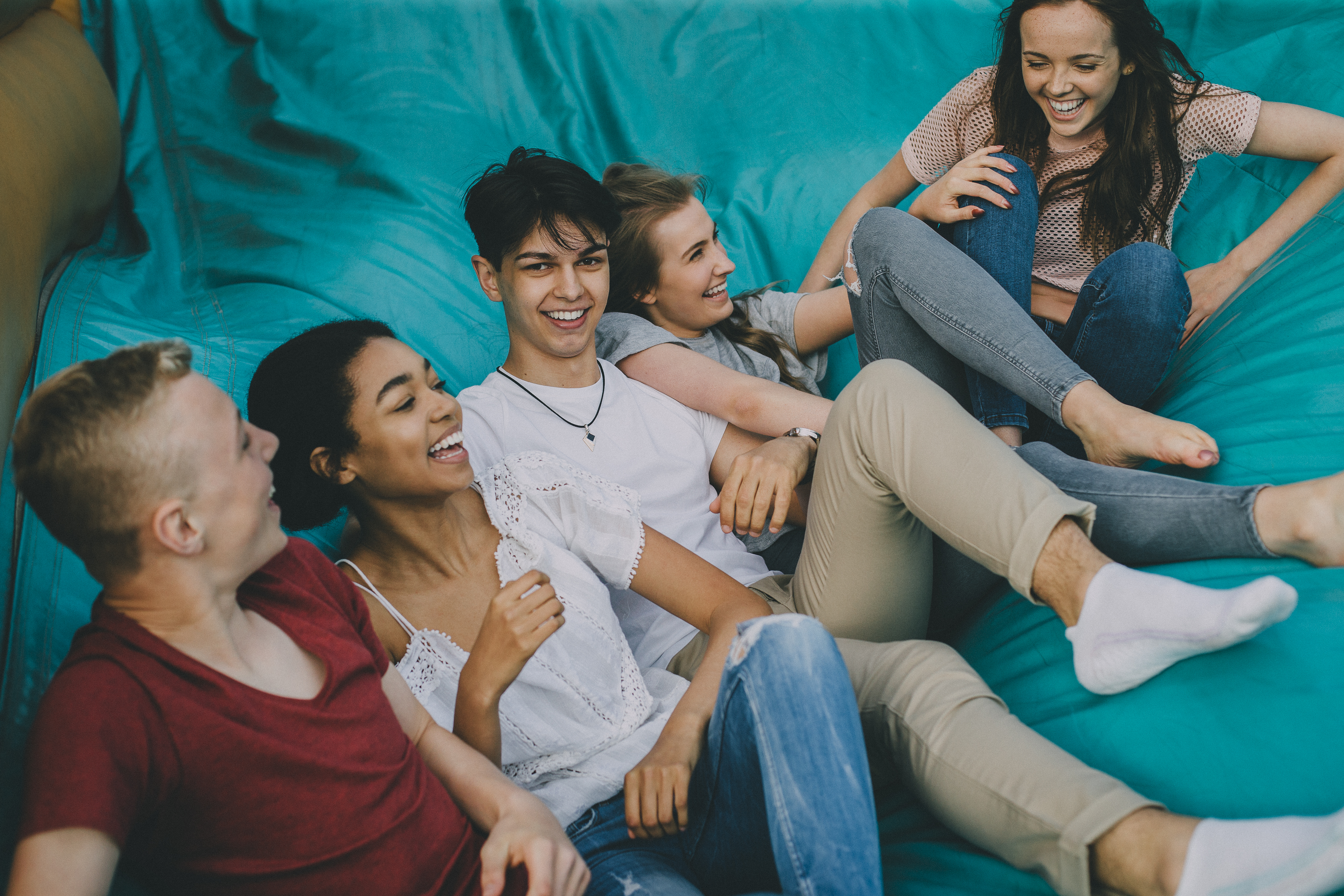 Teens Jumping Down Slide