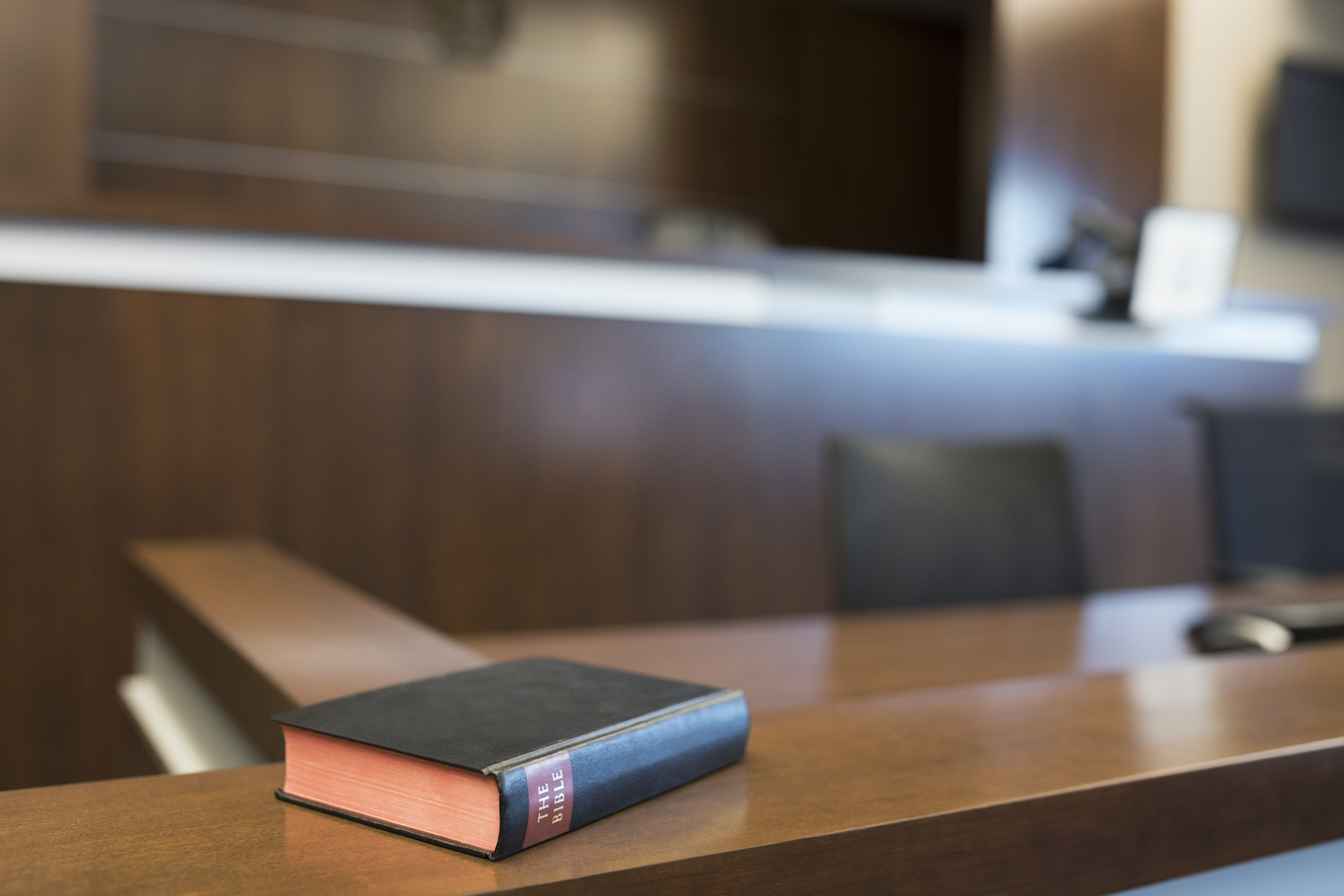 Bible on witness stand in empty courtroom