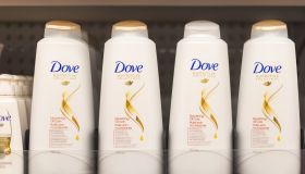 Dove shampoo and conditioner bottles in a shelf. Dove is one...