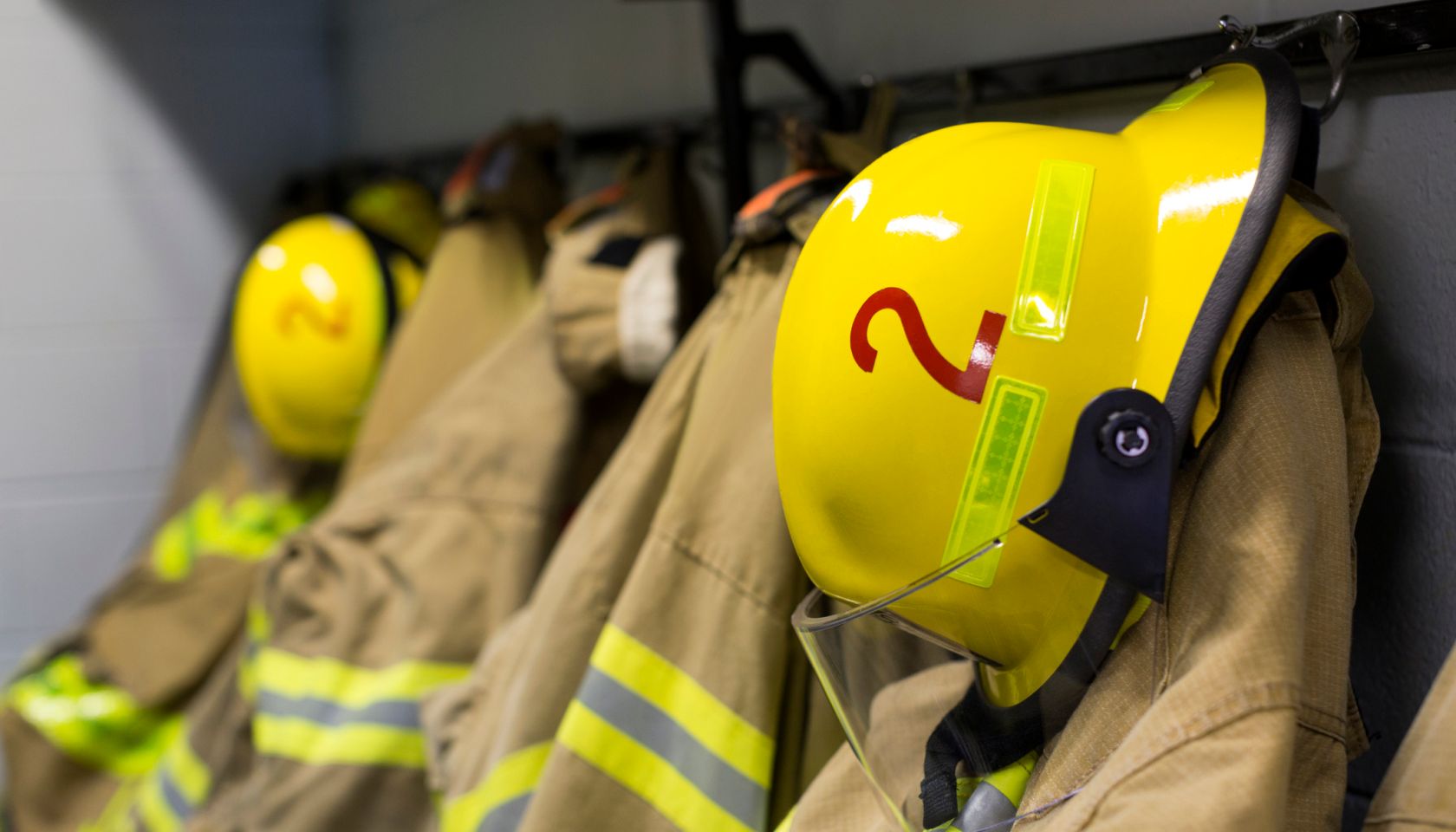 Fire Fighter Coats and helmets of fire fighters hanging on hooks