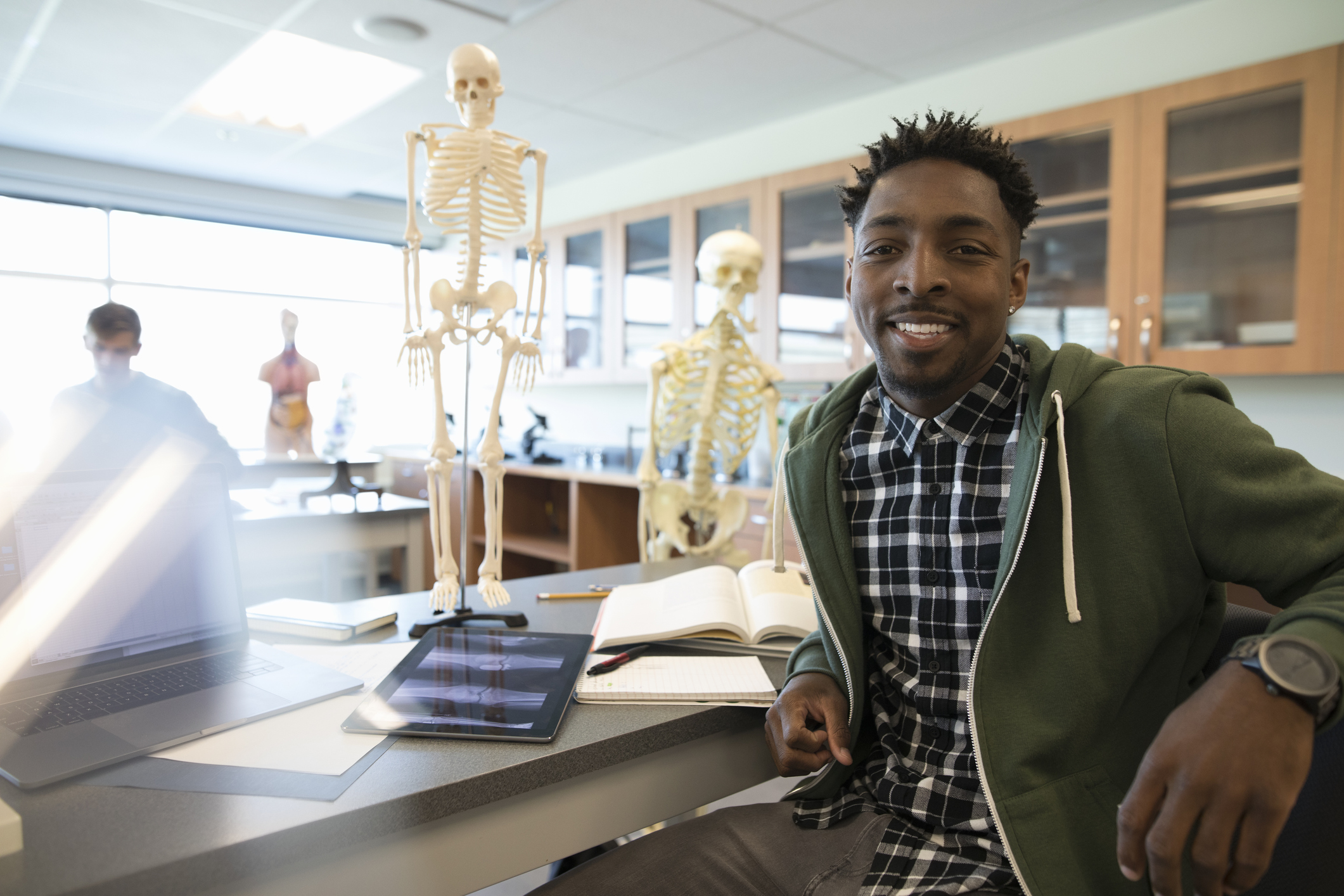 Portrait confident male college student in anatomy laboratory classroom