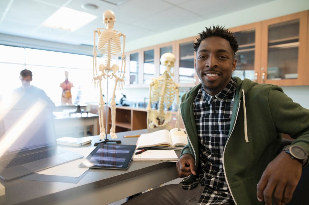 Portrait confident male college student in anatomy laboratory classroom