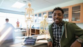 Portrait confident male college student in anatomy laboratory classroom
