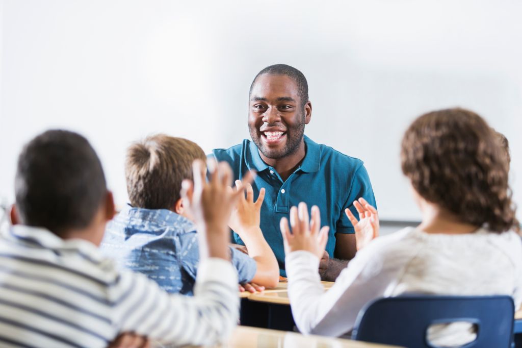 African American teacher and children in classroom