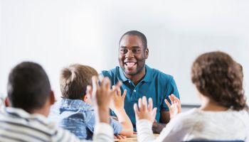 African American teacher and children in classroom