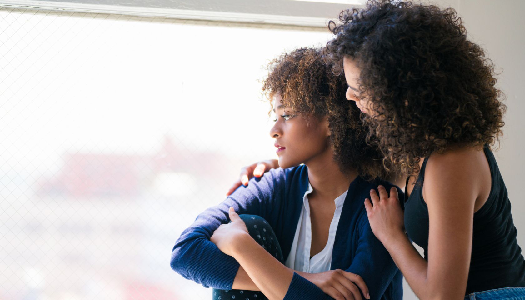 Young woman consoling her friend