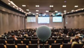 Business meeting concept, Microphone over the Abstract blurred photo of conference hall background
