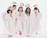 Diverse group of girls wearing angel costumes praying