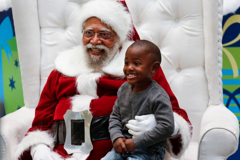 Jahleel Logan, 3, poses with Santa, a.k.a. Langston Patterson, 77, of Rudolph Holiday Photo, at the