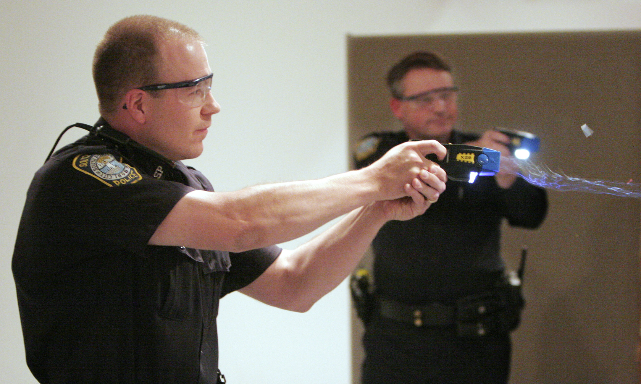Christopher Todd, an officer with the South Portland police department, fires his taser gun during a