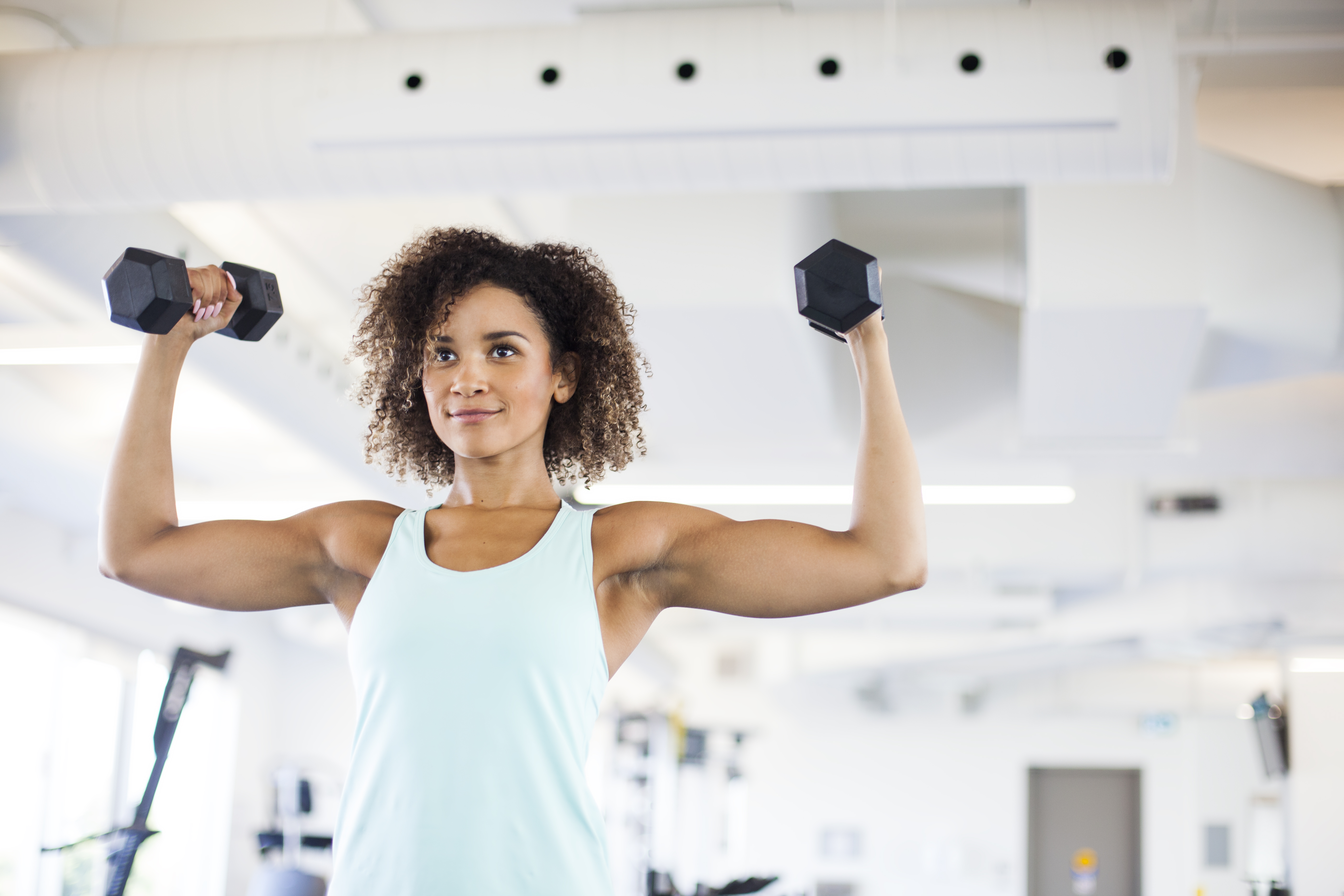 Young Woman Weightraining at the Gym