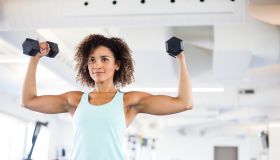 Young Woman Weightraining at the Gym