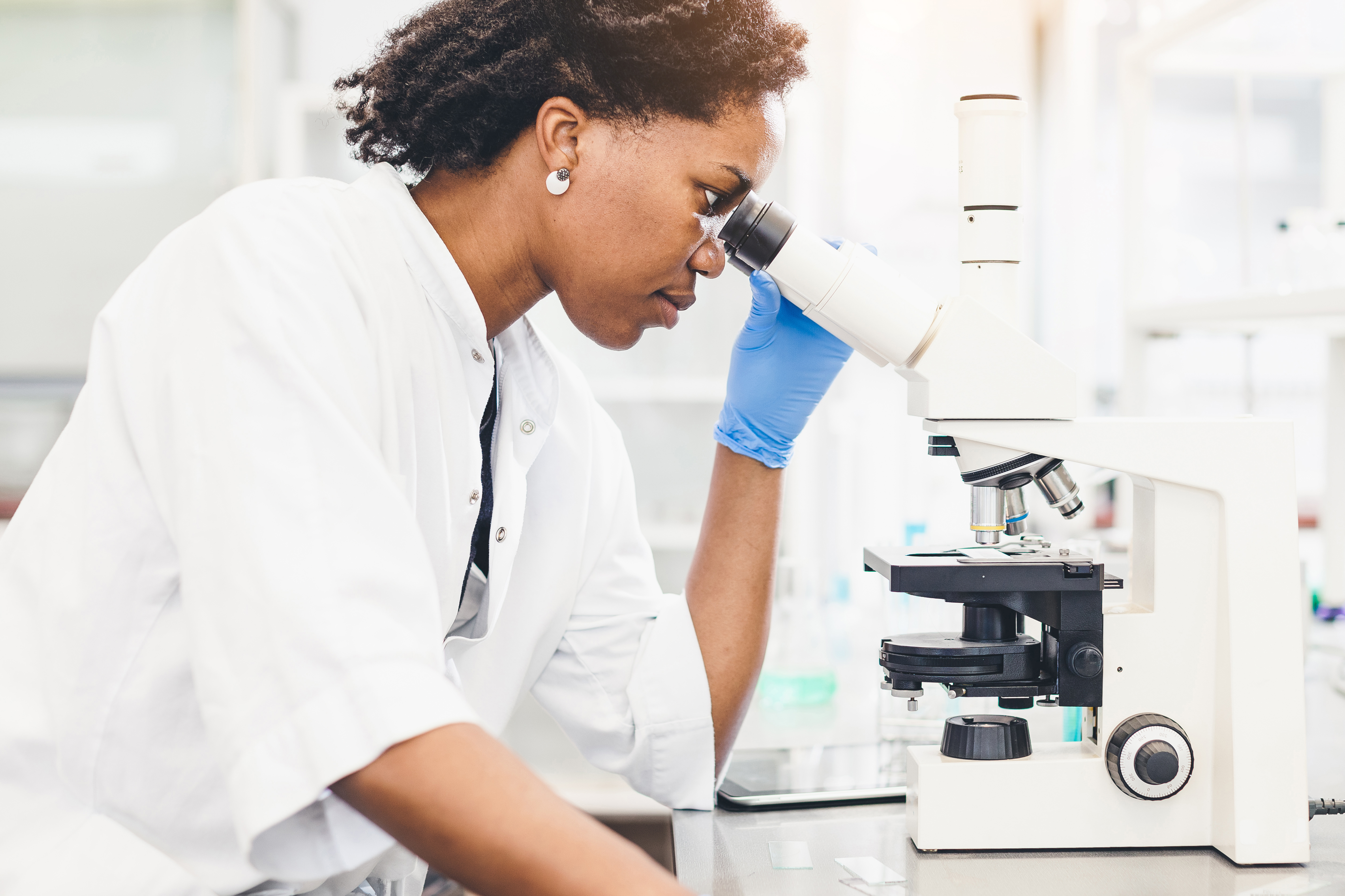 Scientist Looking Through the Microscope