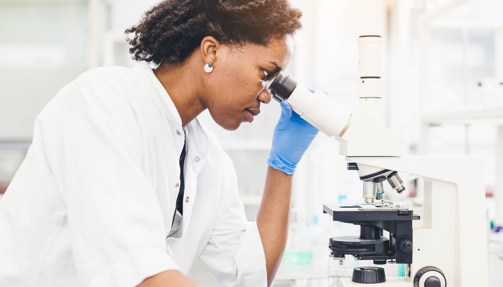 Scientist Looking Through the Microscope