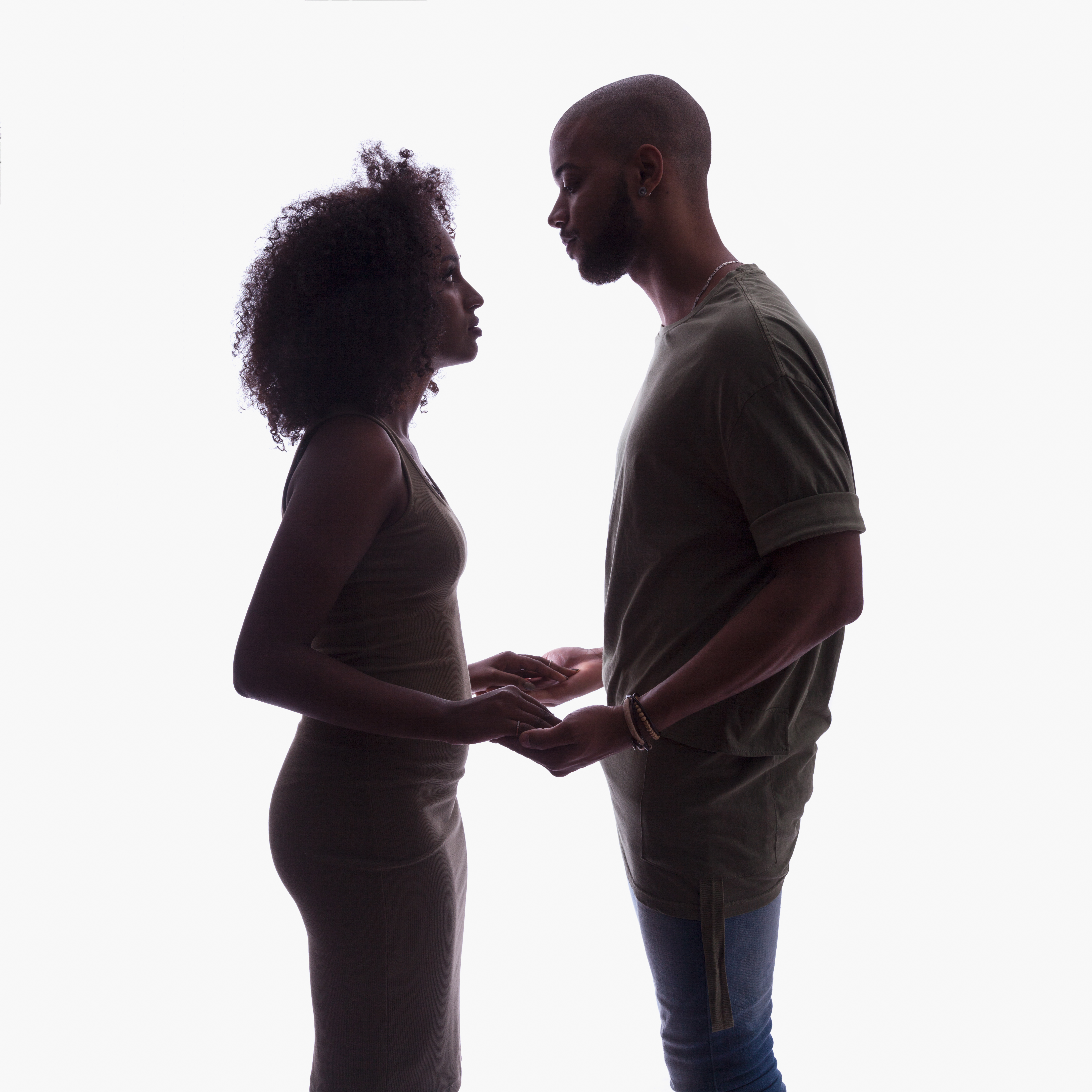 Silhouette of young couple in studio setting