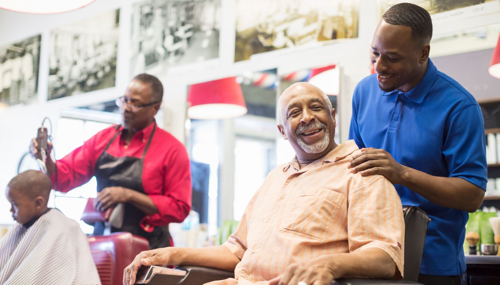 Black barber talking to customer in retro barbershop