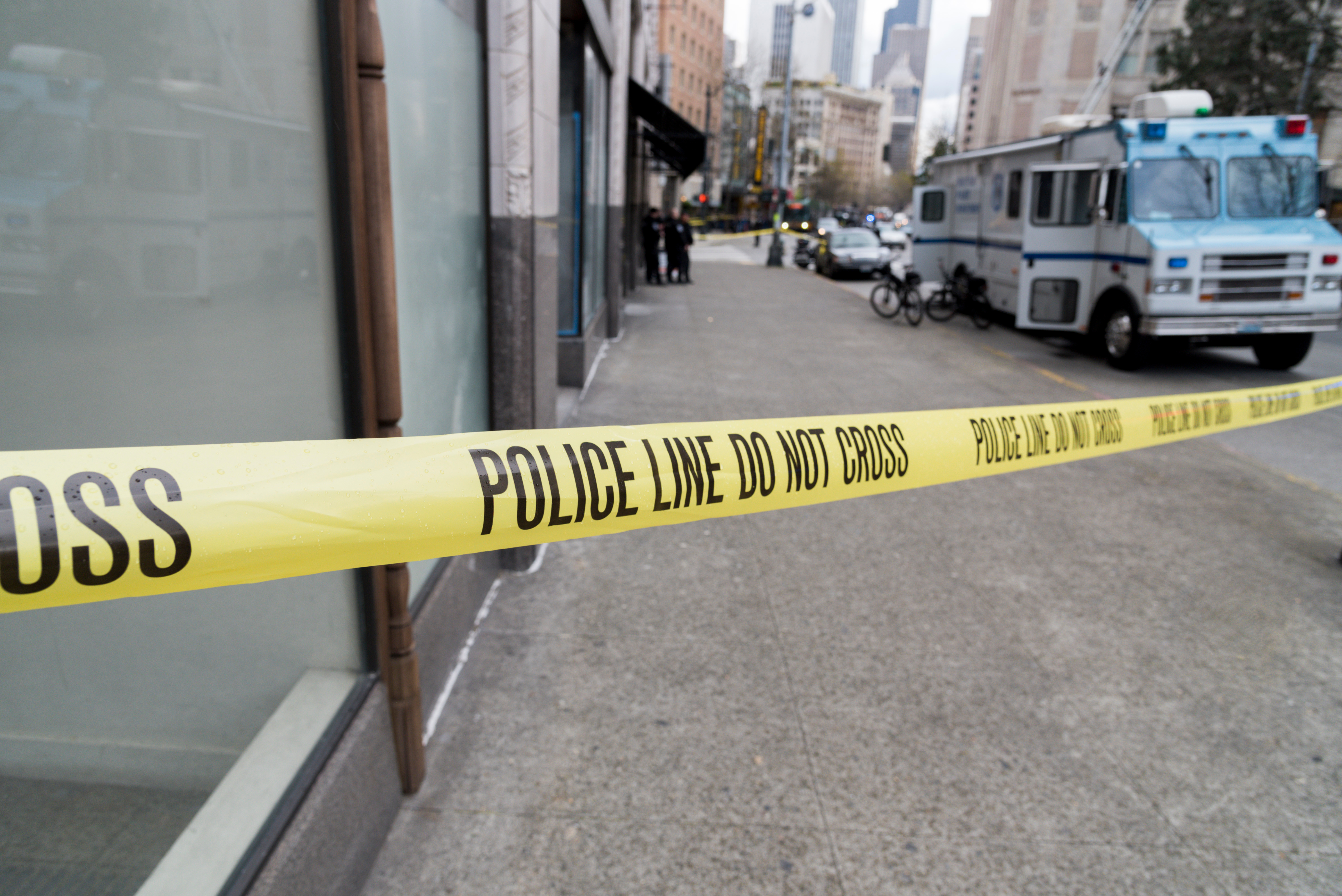 Close-Up Of Cordon Tape With Text On Street In City