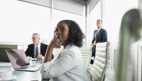 Confident, attentive businesswoman listening in conference room meeting