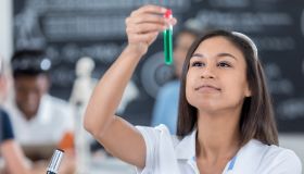 Female student analyzes liquid in test tube