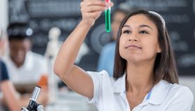 Female student analyzes liquid in test tube