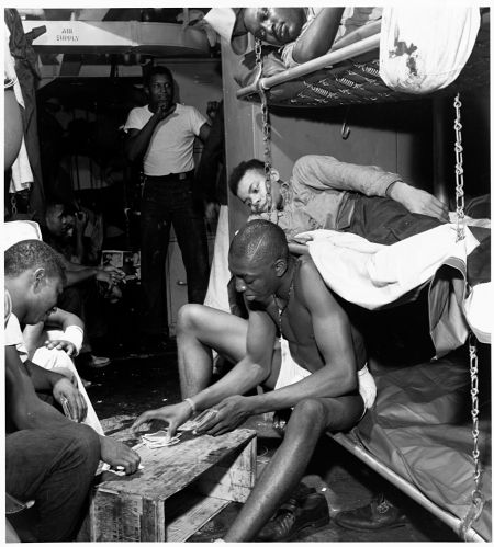 Stewards mates passing time the evening before battle at Manila with a card game in their bunk room. November, 1944.