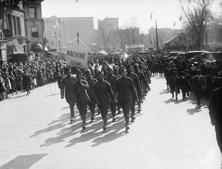 Soldiers Marching with Machine Gun Sign