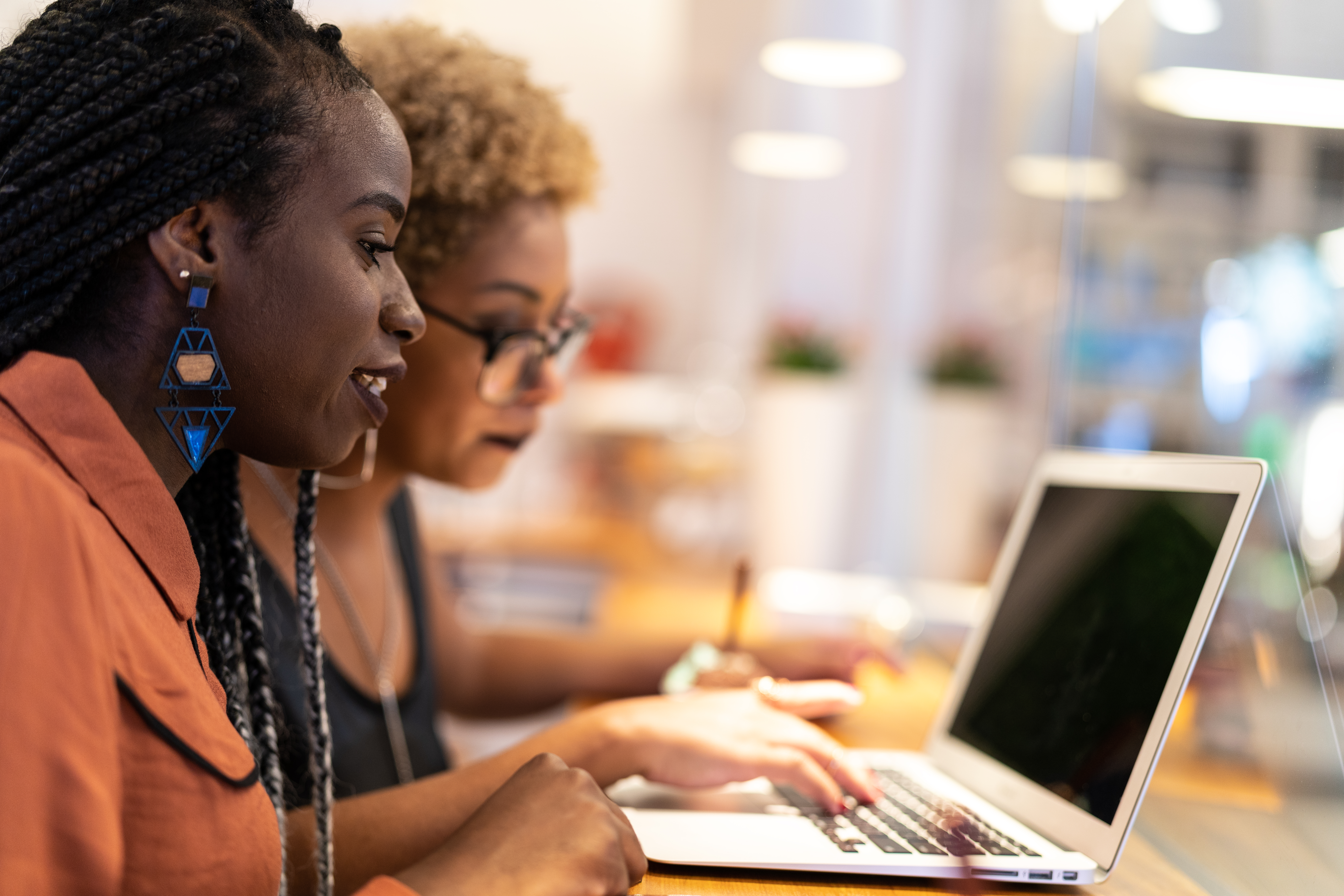 Two Business woman meeting through window