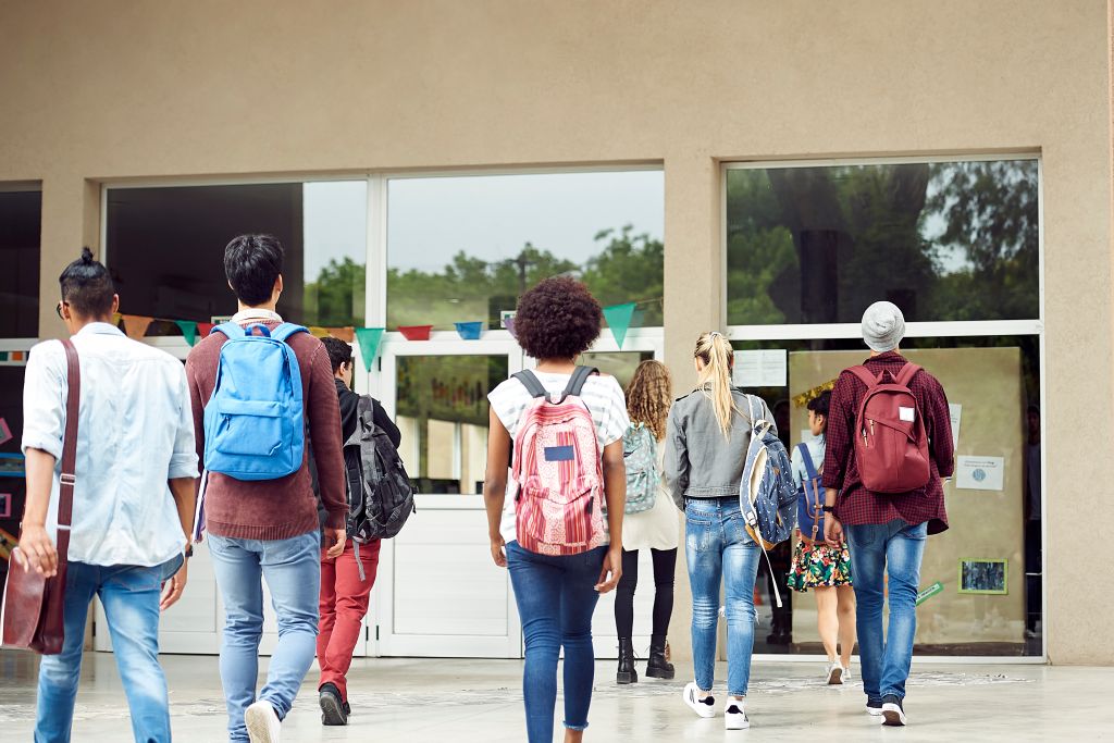 College students walking on campus, rear view