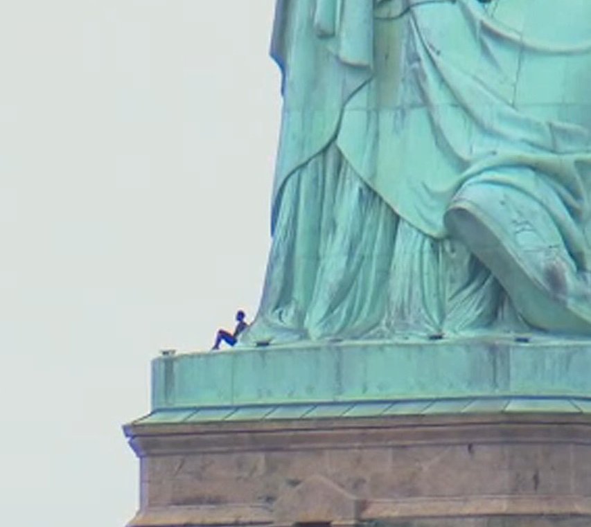 Therese Patricia Okoumou scales the Statue of Liberty on July 4, 2018