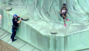 Therese Patricia Okoumou scales the Statue of Liberty on July 4, 2018