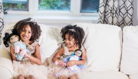 Mixed race sisters playing with dolls