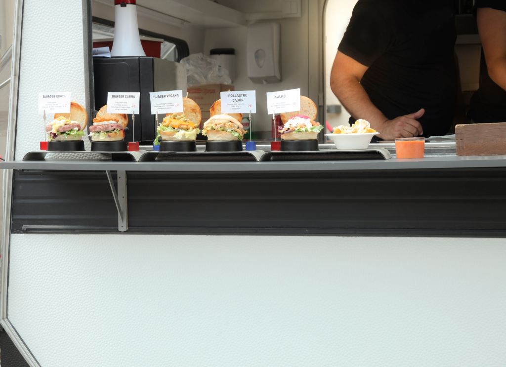Food truck owner serving burger