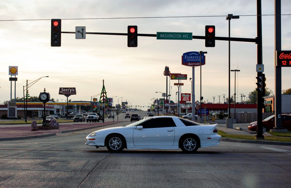 Red traffic light and city street at Weatherford, Oklahoma, USA