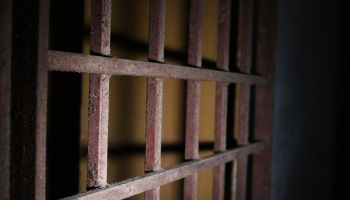 Close-Up Of Rusty Metallic Gate Prison Bars