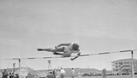 Alice Coachman up and over High Jump Bar