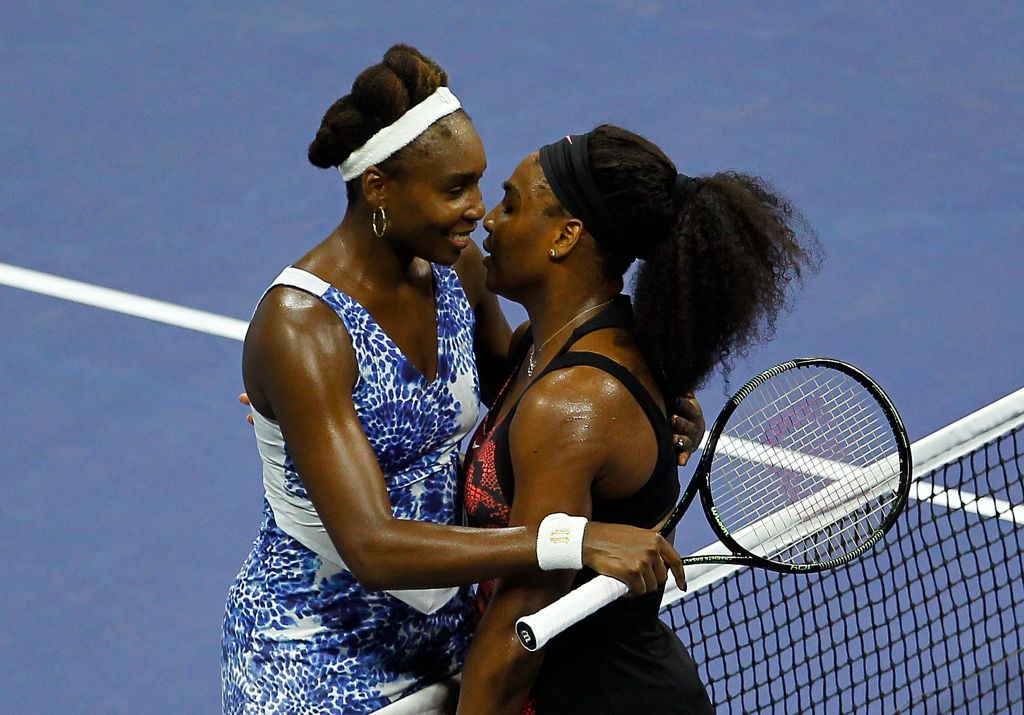 Serena Williams of the U.S. embraces her sister Venus Williams at the net after defeating her in the