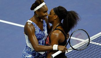 Serena Williams of the U.S. embraces her sister Venus Williams at the net after defeating her in the