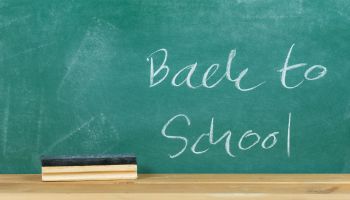 Back To School Text On Blackboard In Classroom