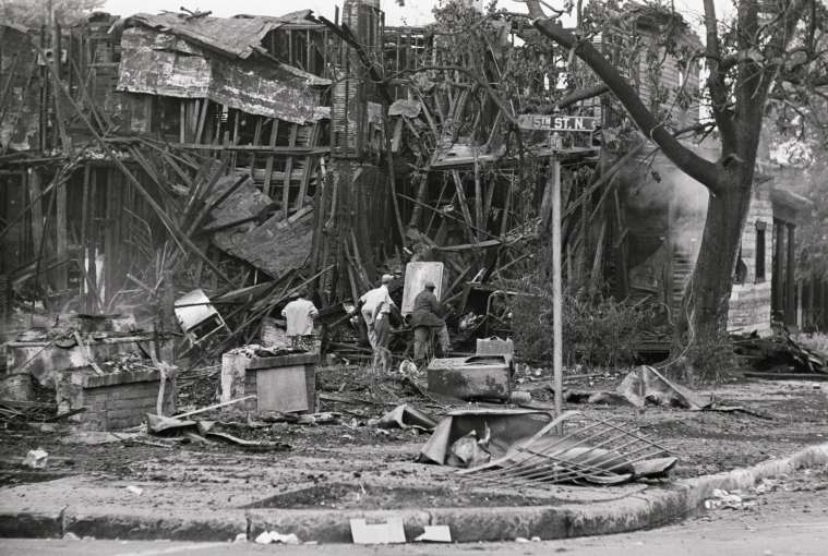Men Searching Wreckage of Burned Building
