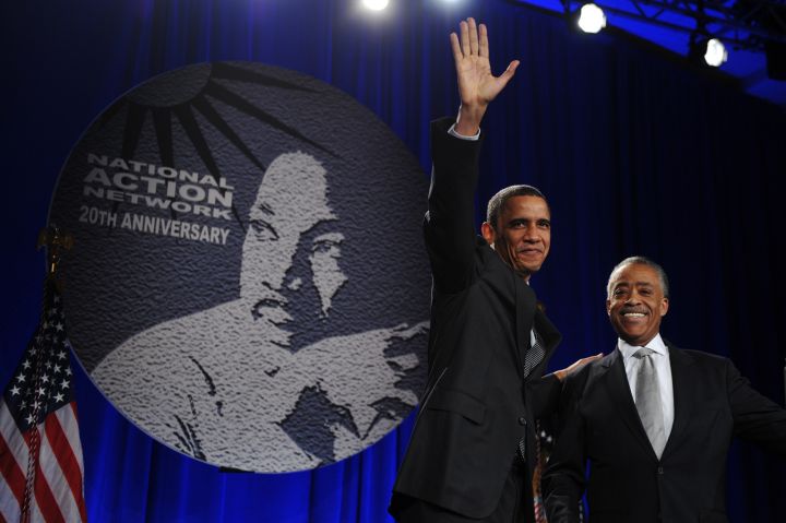 Reverend Al Sharpton stands with US Pres