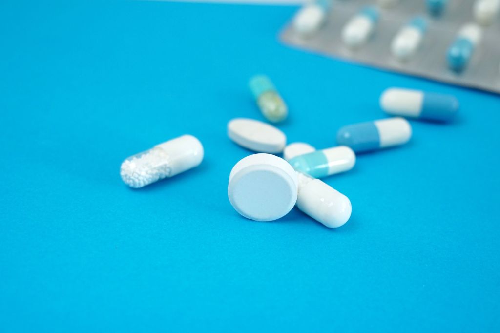 Close-Up Of Medicines Over Blue Background
